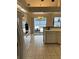 Open kitchen with tile flooring, white appliances, and a view of the pool area at 5294 Elkin Ave, Spring Hill, FL 34606
