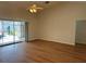 Bright living area showcasing hardwood floors and a view to the screened in pool at 5294 Elkin Ave, Spring Hill, FL 34606