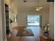 Spacious living room with hardwood floors, a ceiling fan, and sliding glass doors leading to the pool at 5294 Elkin Ave, Spring Hill, FL 34606