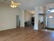 Open-concept living space with hardwood floors, a ceiling fan, and a view of the entryway at 5294 Elkin Ave, Spring Hill, FL 34606