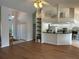 Open living space with hardwood floors, a ceiling fan, and a breakfast bar leading to the kitchen at 5294 Elkin Ave, Spring Hill, FL 34606