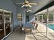 Covered pool patio features fans, dining area, and access to a refreshing swimming pool at 5294 Elkin Ave, Spring Hill, FL 34606