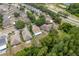 Aerial view displays a neighborhood and houses near a lake and roadways, surrounded by trees at 6125 Desert Peace Ave, Land O Lakes, FL 34639