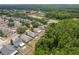 Scenic aerial perspective of houses surrounded by lush green foliage and the neighborhood's layout at 6125 Desert Peace Ave, Land O Lakes, FL 34639