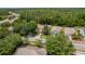 Scenic aerial view of a neighborhood showcasing tree-lined streets and well-maintained properties at 6125 Desert Peace Ave, Land O Lakes, FL 34639