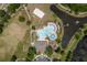 Overhead view of community pool, clubhouse, sand volleyball court and adjacent parking and waterways at 6125 Desert Peace Ave, Land O Lakes, FL 34639
