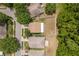 Bird's eye view showcases the home's fenced yard and proximity to neighboring houses and mature trees at 6125 Desert Peace Ave, Land O Lakes, FL 34639
