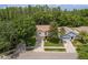 Aerial view of a well-maintained home showcasing its landscaping, roof, and proximity to lush greenery at 6125 Desert Peace Ave, Land O Lakes, FL 34639