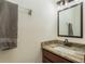 Half bathroom featuring a granite vanity top, new plumbing fixtures, and gray towel at 6125 Desert Peace Ave, Land O Lakes, FL 34639