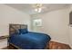 Cozy bedroom featuring hardwood floors, natural lighting and a full bed at 6125 Desert Peace Ave, Land O Lakes, FL 34639
