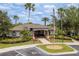 A charming community clubhouse with manicured landscaping and a welcoming entrance and parking at 6125 Desert Peace Ave, Land O Lakes, FL 34639