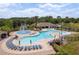 Expansive community pool with wading area, splash pad, covered patio, and plenty of lounge chairs at 6125 Desert Peace Ave, Land O Lakes, FL 34639