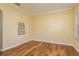 Bright, empty room with hardwood floors, crown molding, and natural light at 6125 Desert Peace Ave, Land O Lakes, FL 34639