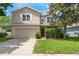 Charming two-story home featuring a well-manicured lawn and a two-car garage at 6125 Desert Peace Ave, Land O Lakes, FL 34639