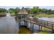 Overhead shot of a community gazebo on a pier, overlooking a calm pond with fountain feature at 6125 Desert Peace Ave, Land O Lakes, FL 34639