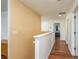 Hallway with hardwood flooring and a staircase leads to other rooms in the house at 6125 Desert Peace Ave, Land O Lakes, FL 34639