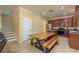 Open kitchen and dining area with breakfast table, stainless appliances, and staircase to upper level at 6125 Desert Peace Ave, Land O Lakes, FL 34639