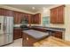 Kitchen featuring stainless steel appliances, granite countertops, and dark wood cabinetry at 6125 Desert Peace Ave, Land O Lakes, FL 34639