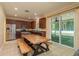 Eat-in kitchen with stainless steel appliances, breakfast table, and sliding glass door to lanai at 6125 Desert Peace Ave, Land O Lakes, FL 34639