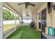 This is an expansive screened patio featuring an outdoor dining set and comfortable seating for entertaining at 6125 Desert Peace Ave, Land O Lakes, FL 34639