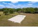Aerial shot of a sand volleyball court in a well-maintained community park setting on a sunny day at 6125 Desert Peace Ave, Land O Lakes, FL 34639