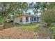 Exterior view of the home's backyard featuring lush green grass and foliage at 6172 Prestwick Ct, Spring Hill, FL 34606