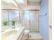 Bright bathroom featuring a shower with glass doors and white vanity at 6172 Prestwick Ct, Spring Hill, FL 34606