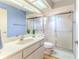 Bathroom features a glass enclosed shower, vanity with sink and toilet at 6172 Prestwick Ct, Spring Hill, FL 34606