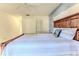 Bright bedroom features a comfortable bed, white bedding and walls, and closet at 6172 Prestwick Ct, Spring Hill, FL 34606
