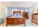Cozy bedroom featuring wood furniture, a ceiling fan, and a relaxing atmosphere at 6172 Prestwick Ct, Spring Hill, FL 34606