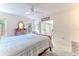 A bedroom with neutral colored walls, a large window and a sunroom with pink chairs at 6172 Prestwick Ct, Spring Hill, FL 34606