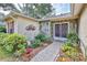 Charming home entrance with stone accents, well-maintained landscaping, and a brick walkway leading to the front door at 6172 Prestwick Ct, Spring Hill, FL 34606