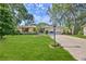Inviting single-story home with manicured lawn, red shutters, and paved driveway leading to the attached garage at 6172 Prestwick Ct, Spring Hill, FL 34606