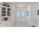 Inviting foyer with tile flooring, a decorative cabinet, and double doors with obscured glass at 6172 Prestwick Ct, Spring Hill, FL 34606