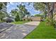 Charming home exterior featuring a well-manicured lawn, a beautiful driveway and lush foliage at 6172 Prestwick Ct, Spring Hill, FL 34606