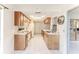 Spacious kitchen with wood cabinets, modern appliances, and view into the sunroom at 6172 Prestwick Ct, Spring Hill, FL 34606