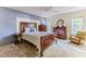 Comfortable main bedroom with wood furniture, neutral carpet, and large windows for natural light at 6172 Prestwick Ct, Spring Hill, FL 34606