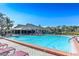 Large outdoor community pool with lounge chairs and covered seating area near the clubhouse at 6172 Prestwick Ct, Spring Hill, FL 34606
