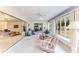 Sun room with ceiling fan, large windows overlooking trees, and a sliding glass door at 6172 Prestwick Ct, Spring Hill, FL 34606