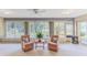 Sun room with a large window, ceiling fan, two chairs, a small table and neutral colored carpet at 6172 Prestwick Ct, Spring Hill, FL 34606
