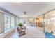 Bright sunroom with pink chairs, ceiling fan, and big windows with a view to the outside at 6172 Prestwick Ct, Spring Hill, FL 34606