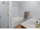 Bathroom features a double sink vanity, bathtub, and tile floors at 6273 Pinehurst Dr, Spring Hill, FL 34606