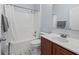 Full bathroom with a shower-tub combo, white tile, and a wood vanity at 6273 Pinehurst Dr, Spring Hill, FL 34606