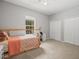 Bright bedroom with a ceiling fan, carpeted floors, double closets and a twin bed at 6273 Pinehurst Dr, Spring Hill, FL 34606