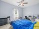 Bedroom featuring carpeted floors, ceiling fan, and a blue bed spread at 6273 Pinehurst Dr, Spring Hill, FL 34606