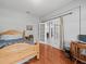 Bedroom featuring hardwood floors, French doors, and a wooden bed frame at 6273 Pinehurst Dr, Spring Hill, FL 34606