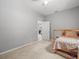 Neutral bedroom featuring a ceiling fan, carpeted floors, and twin bed at 6273 Pinehurst Dr, Spring Hill, FL 34606