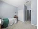 Bedroom with neutral carpet, closet, and an open door at 6273 Pinehurst Dr, Spring Hill, FL 34606