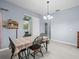 Dining room includes table and chairs with natural light from sliding glass doors at 6273 Pinehurst Dr, Spring Hill, FL 34606
