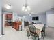 Dining room has a table and chairs, is adjacent to the kitchen and living room at 6273 Pinehurst Dr, Spring Hill, FL 34606